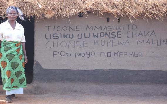 This sign reads, “Let’s sleep under a net every night throughout the year to prevent malaria – Life is precious. 