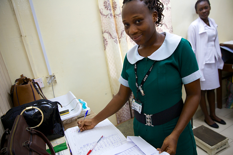 A nurse at the ANC clinic at the a Regional Hospital fills in the patient registry that tracks if pregnant women have attended the required ANC and their health status.